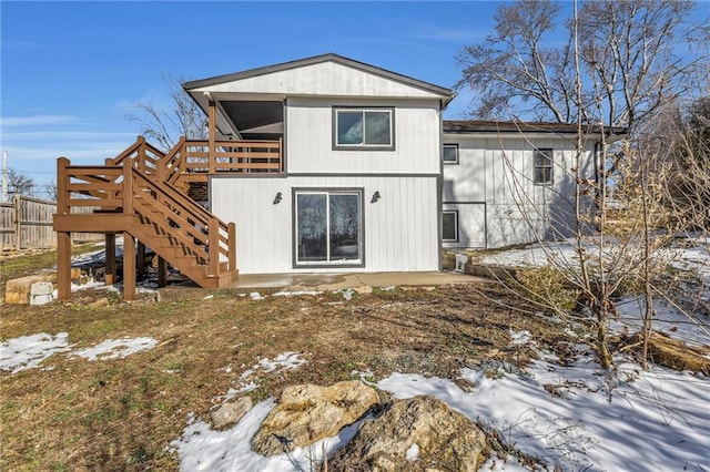 back of house with fence, stairway, and a wooden deck