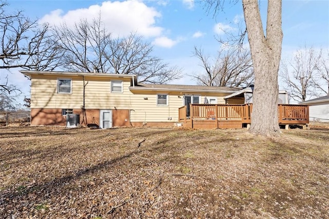 back of house with central AC unit and a wooden deck