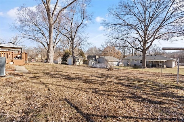 view of yard featuring fence and a deck