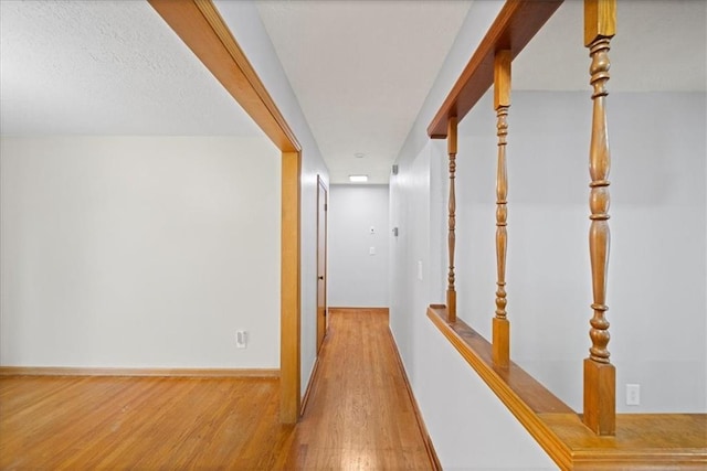 hall with hardwood / wood-style flooring