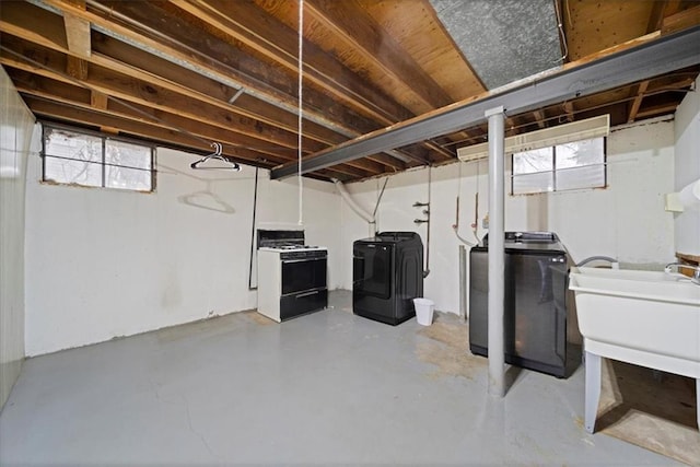 basement with washing machine and clothes dryer and sink