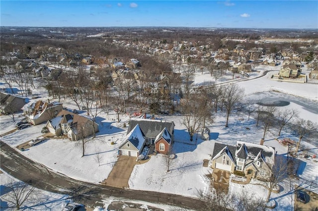 snowy aerial view with a residential view