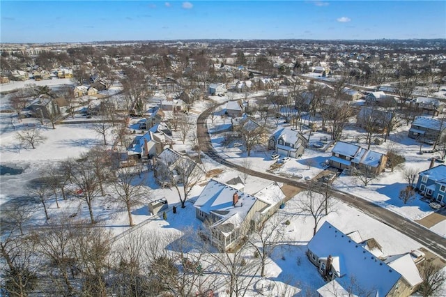 snowy aerial view with a residential view