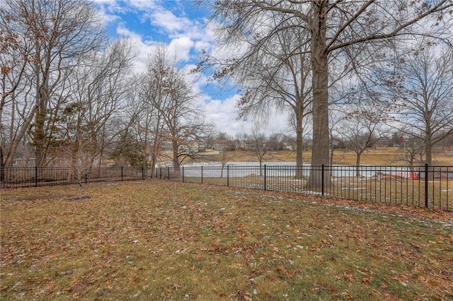 view of yard with a water view and fence