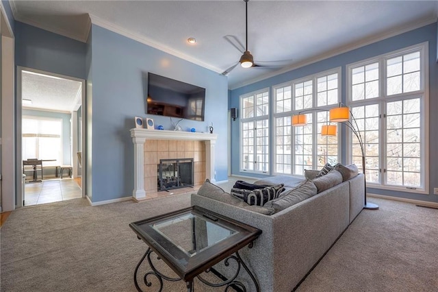 living room with baseboards, light carpet, crown molding, and a tiled fireplace