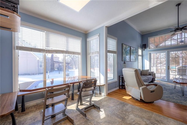 dining area featuring a ceiling fan, baseboards, crown molding, and wood finished floors