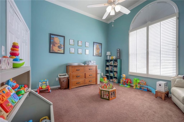 rec room with carpet, a ceiling fan, and crown molding