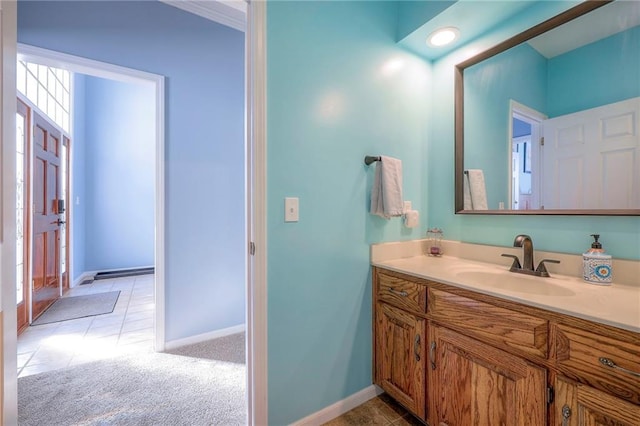 bathroom with tile patterned flooring, vanity, and baseboards