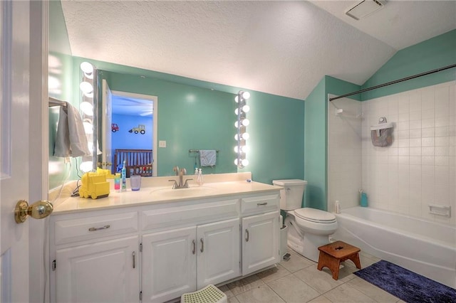 bathroom featuring tile patterned flooring, vaulted ceiling, a textured ceiling, vanity, and washtub / shower combination