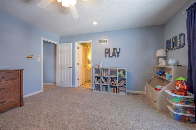 rec room featuring light carpet, visible vents, a ceiling fan, and baseboards