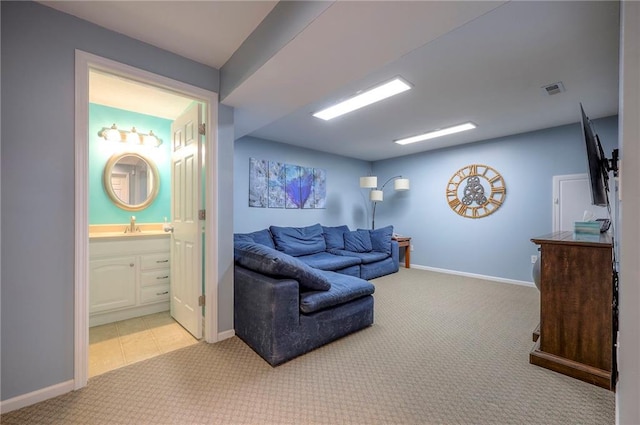 living area featuring light carpet, visible vents, and baseboards