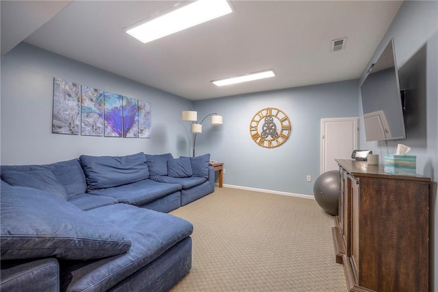 living area with baseboards, visible vents, and light colored carpet