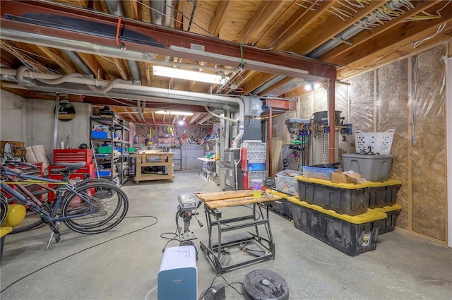 unfinished basement featuring a workshop area