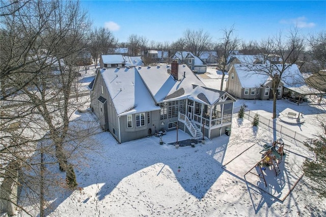 snowy aerial view featuring a residential view