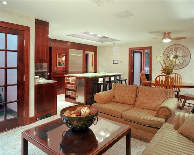 living room featuring sink and ceiling fan