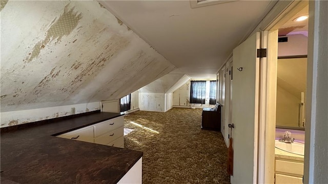 bonus room featuring lofted ceiling and carpet flooring