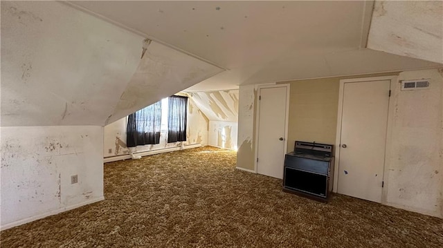 bonus room with visible vents, lofted ceiling, carpet, and a baseboard heating unit