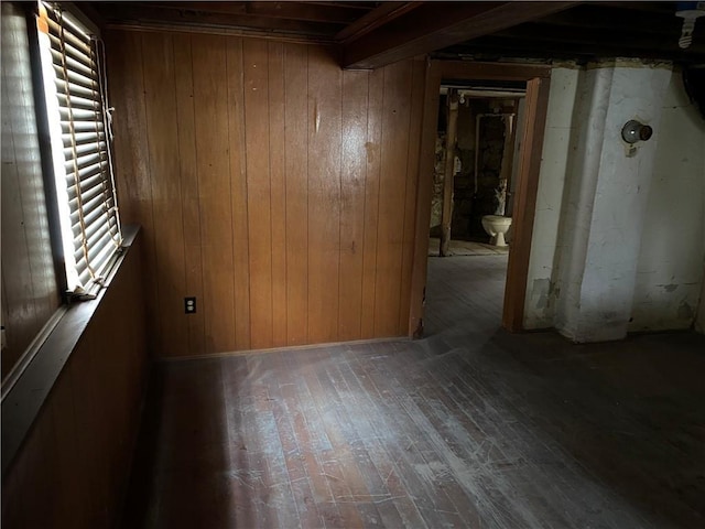 empty room featuring hardwood / wood-style flooring and wood walls