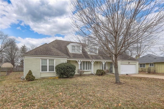 cape cod home featuring a garage and a front lawn