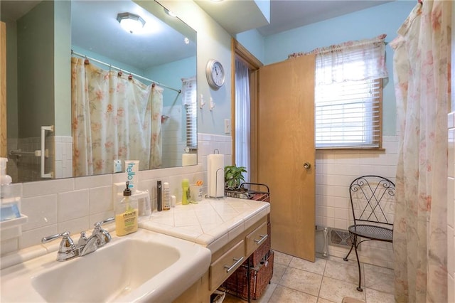 10111 E 86th Ter, Raytown, MO 64138 - bathroom with a shower with curtain, tile patterned flooring, sink, and tile walls