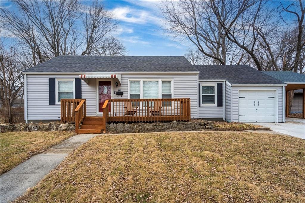 single story home featuring a garage and a front yard