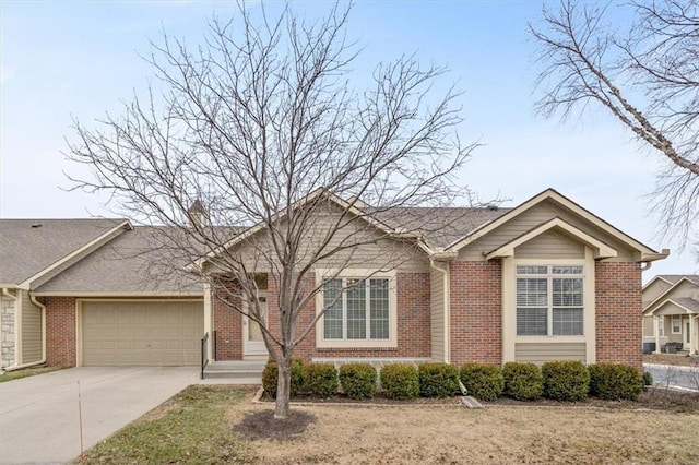 ranch-style home featuring a garage, concrete driveway, and brick siding