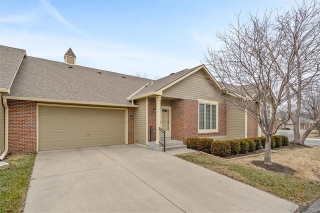 ranch-style home with an attached garage, roof with shingles, concrete driveway, and brick siding