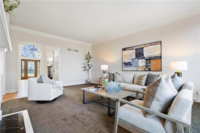 living area with french doors, visible vents, crown molding, and baseboards