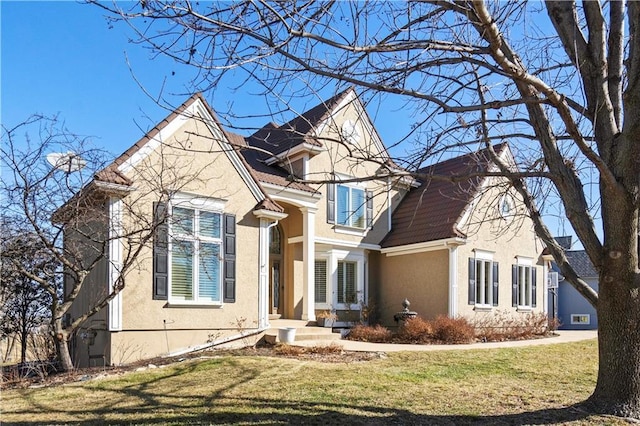 view of front of house featuring a front lawn and stucco siding