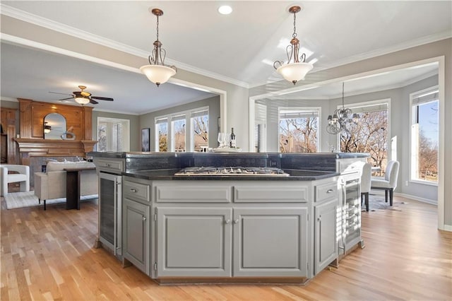 kitchen featuring crown molding, stainless steel gas stovetop, and light wood finished floors