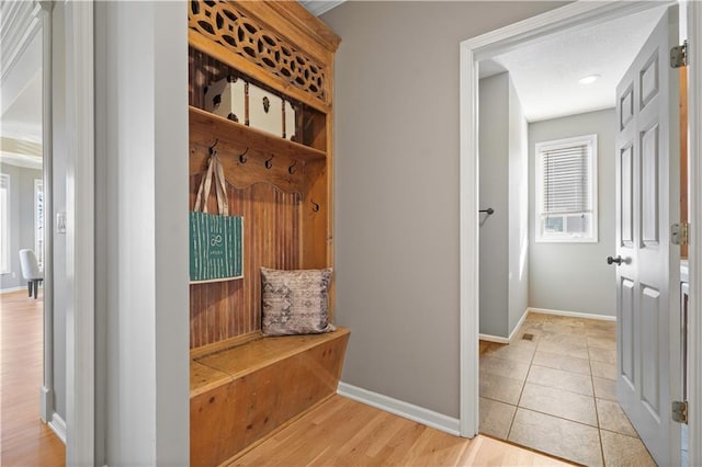 mudroom with tile patterned flooring and baseboards