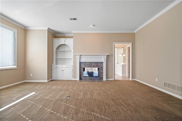 unfurnished living room with light colored carpet, a fireplace, visible vents, baseboards, and ornamental molding