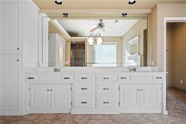 full bathroom with double vanity, tiled shower, a sink, and a ceiling fan