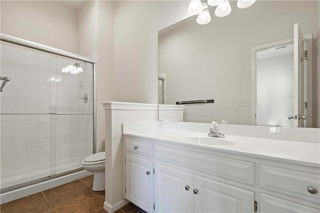 bathroom featuring vanity, tile patterned flooring, a shower stall, and toilet