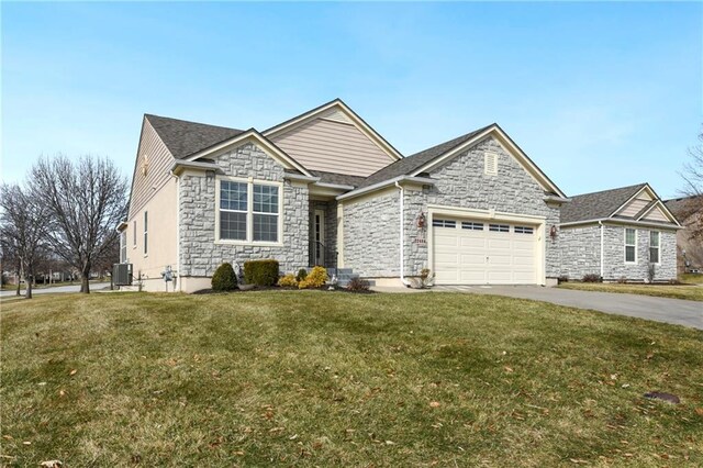 22484 W 113th St, Olathe, KS 66061 - view of front of house with driveway, central AC unit, stone siding, an attached garage, and a front yard