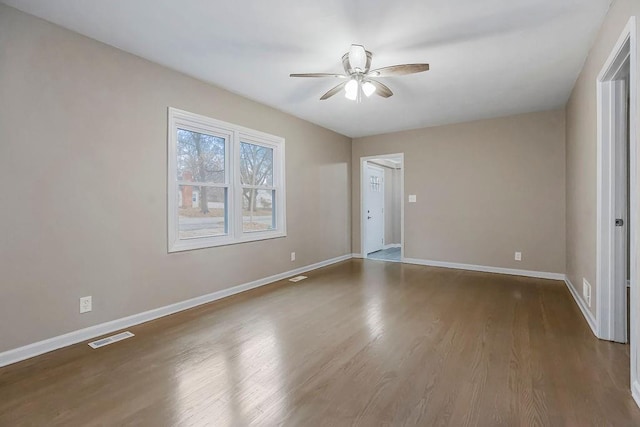 spare room featuring hardwood / wood-style flooring and ceiling fan