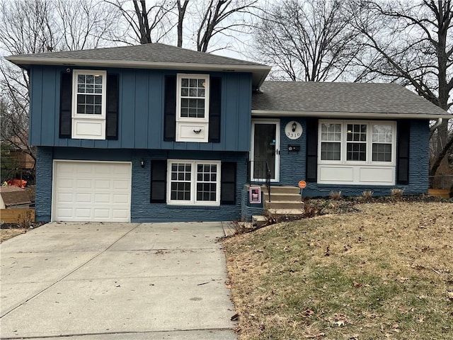 split level home with a garage and a front yard