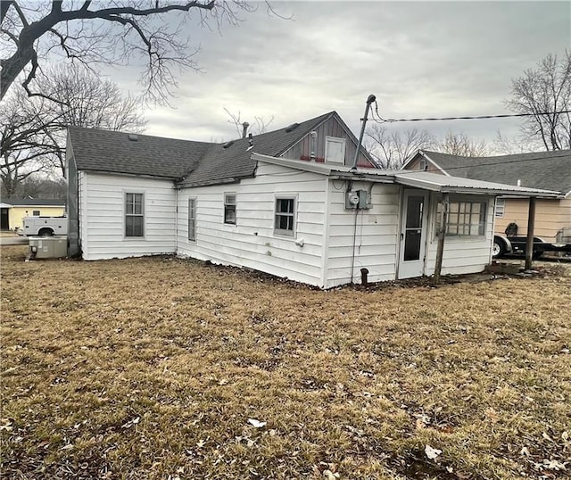 back of house with a lawn