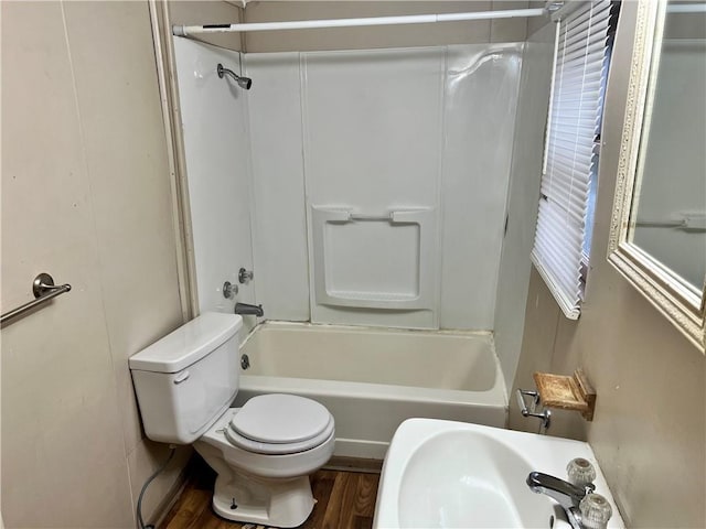 full bathroom featuring hardwood / wood-style flooring, bathtub / shower combination, sink, and toilet