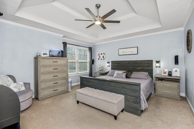carpeted bedroom with crown molding, ceiling fan, and a tray ceiling