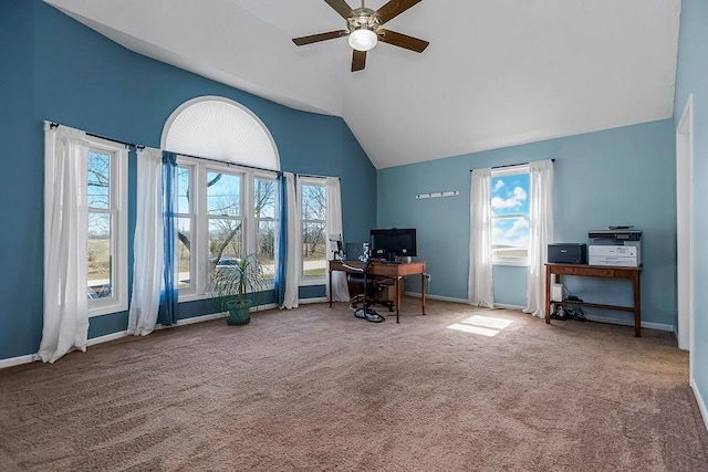 carpeted office space featuring vaulted ceiling, a ceiling fan, and baseboards