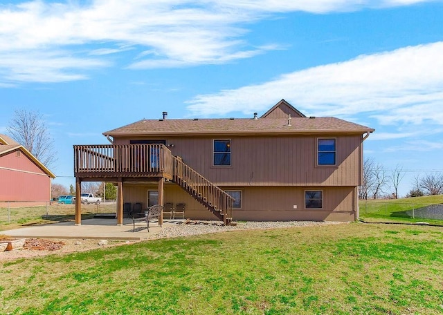 back of property with a lawn, a deck, a patio, fence, and stairs