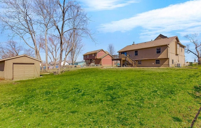 view of yard with stairs and an outbuilding