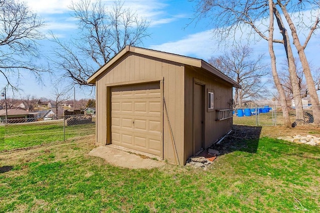 detached garage with driveway and fence