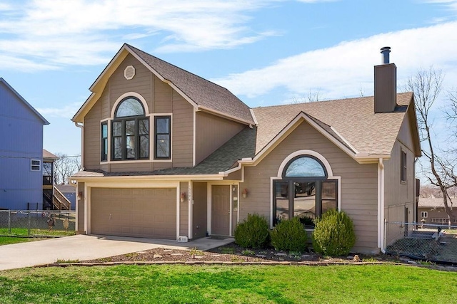 traditional-style house featuring a chimney, an attached garage, concrete driveway, and fence