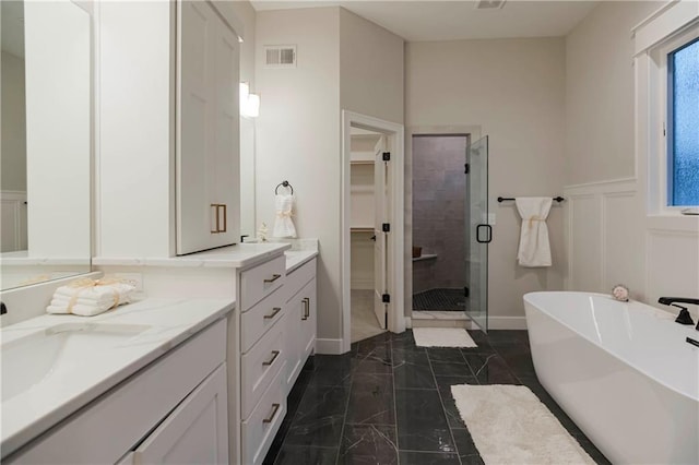 12505 W 184th St, Overland Park, KS 66013 - bathroom with a stall shower, marble finish flooring, vanity, a walk in closet, and a freestanding bath