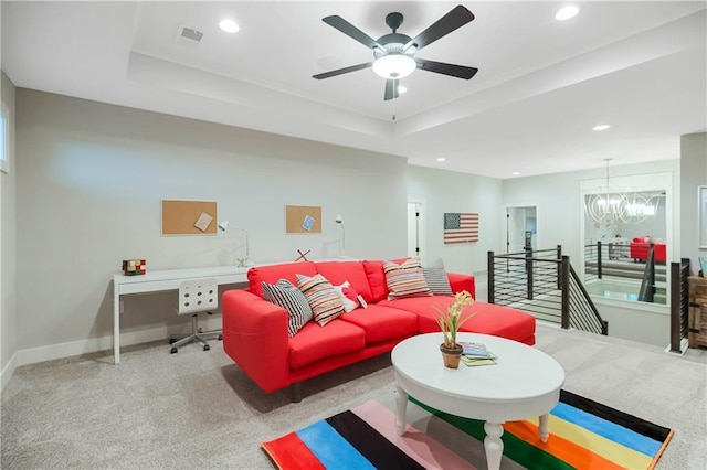 12505 W 184th St, Overland Park, KS 66013 - carpeted living area featuring a raised ceiling, baseboards, recessed lighting, ceiling fan, and a chandelier
