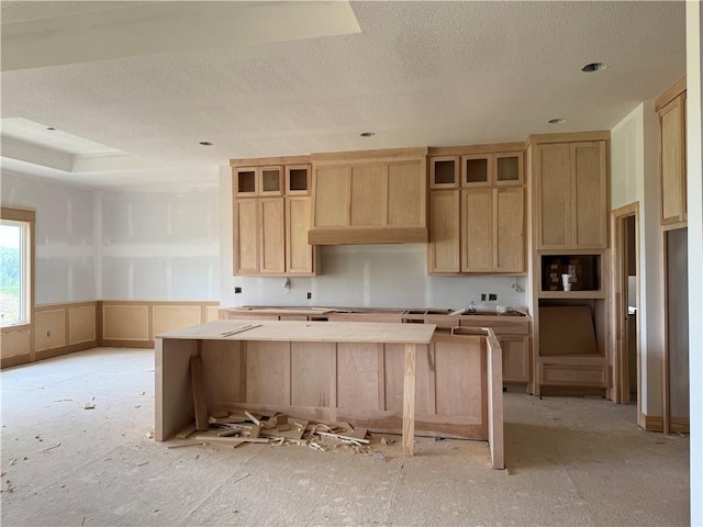 12505 W 184th St, Overland Park, KS 66013 - kitchen with light brown cabinets, a textured ceiling, a center island, custom exhaust hood, and glass insert cabinets