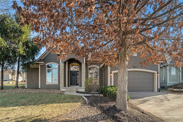 view of property hidden behind natural elements with a front yard, an attached garage, driveway, and stucco siding