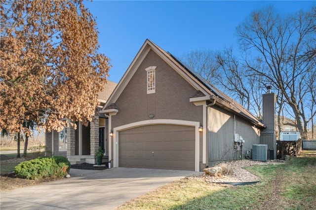 view of front of house featuring central air condition unit, stucco siding, an attached garage, and driveway